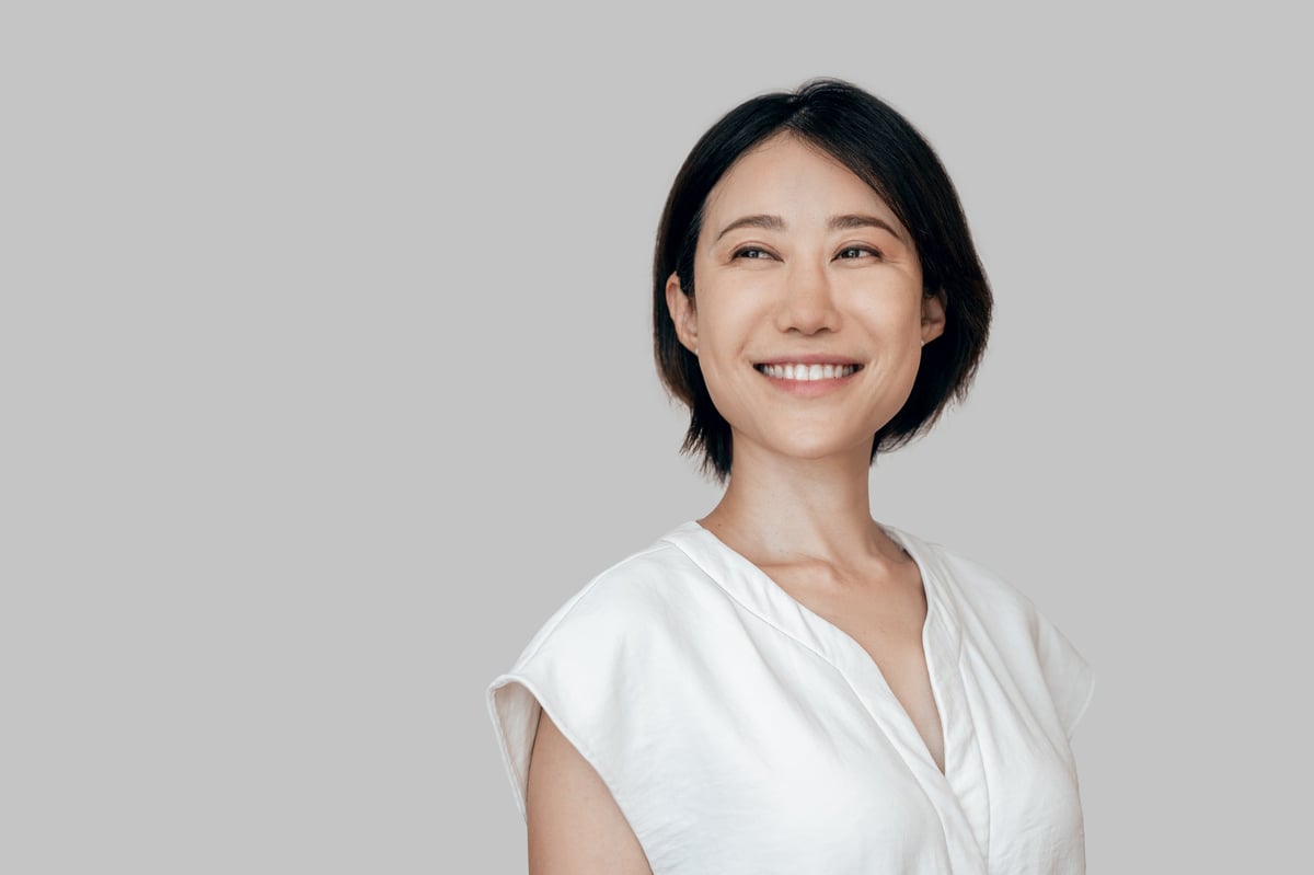 Smiling eastern middle age female entrepreneur ceo leader businesswoman isolated